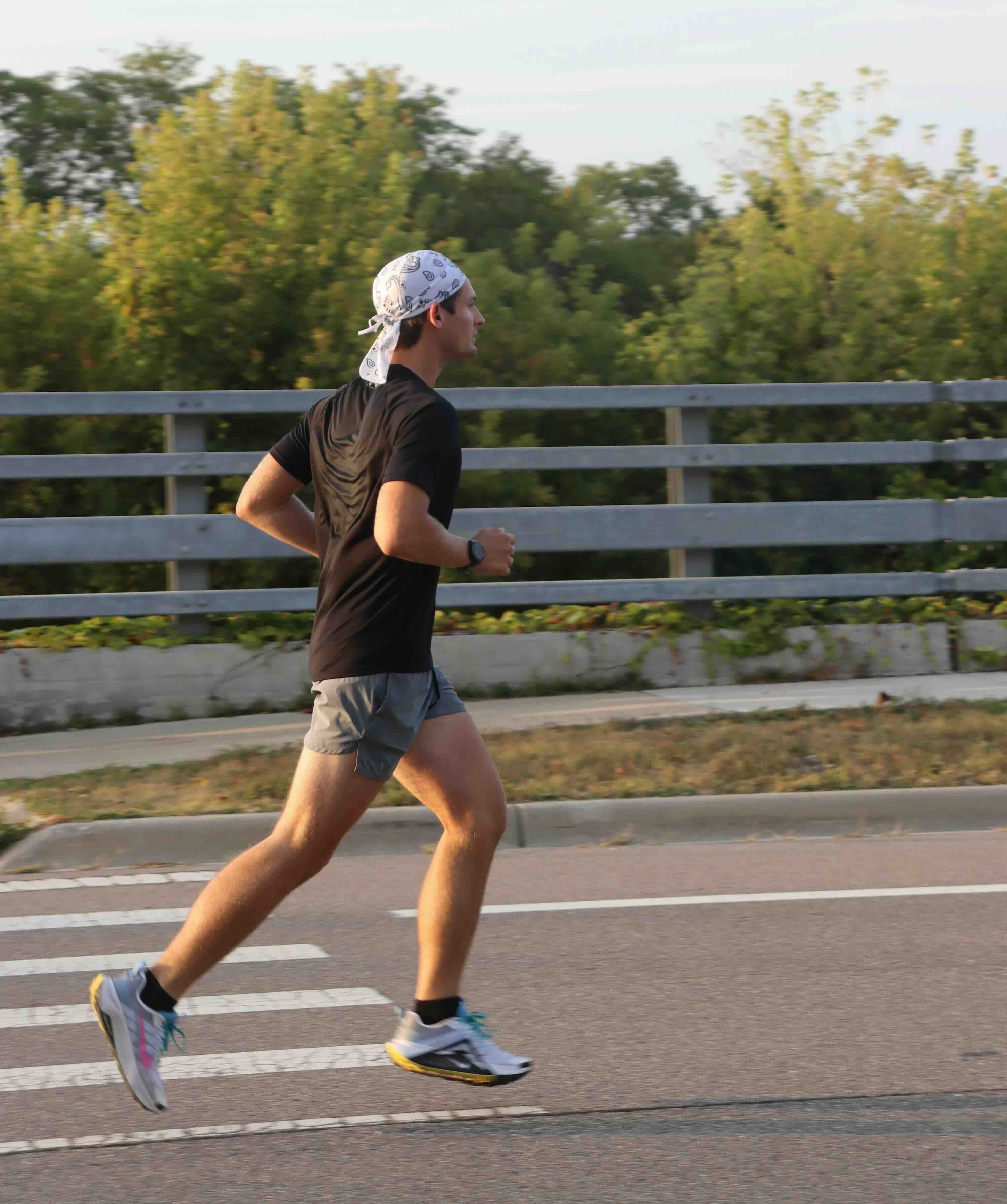 A long distance marathon runner, jogging in a park.
