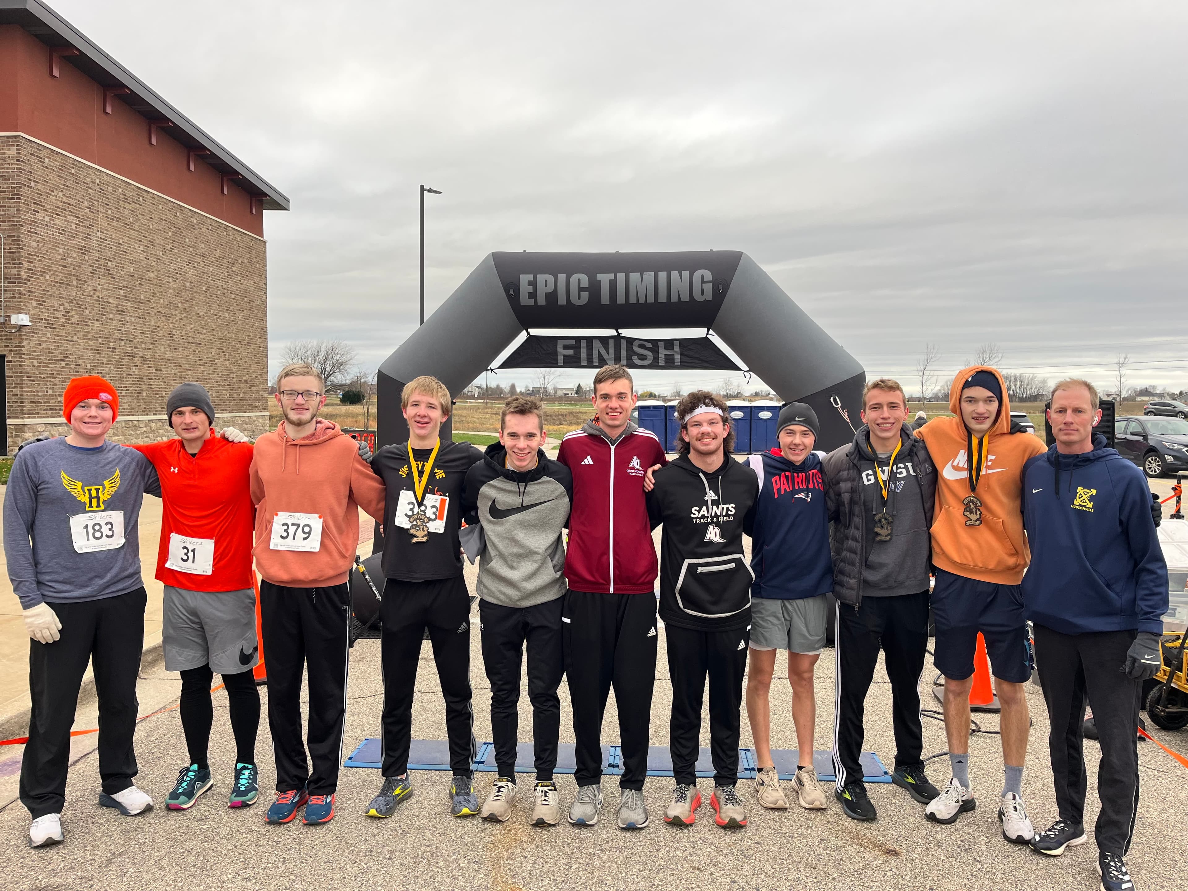 A long distance marathon runner, jogging along a wooded trail.